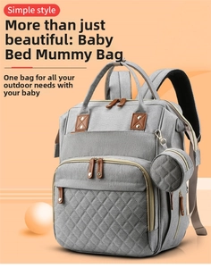 Detail view of the gray portable diaper bag with built-in crib and water-resistant fabric