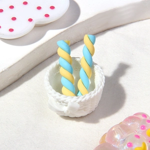 Close-up of resin candy sticks in a tiny woven basket for DIY phone case crafts