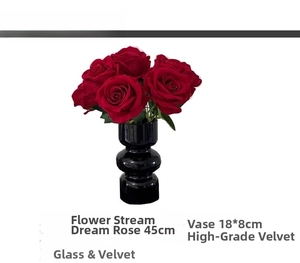 Detailed view of artificial red velvet roses in a black glass vase for home decor