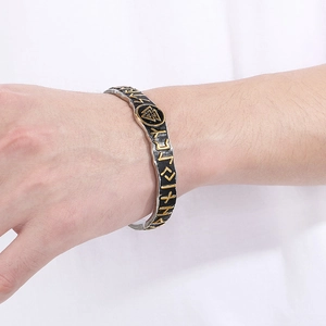 Detailed shot of Viking Valknut bangle with silver and gold Odin runes on stainless steel