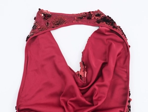 Detailed view of red sequin halter neckline and smooth fabric on party dress