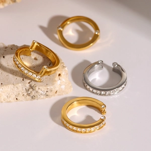 Set of minimalist gold and silver rings featuring sparkling cubic zirconia details on stone
