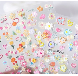 Close-up of 5D embossed nail stickers featuring floral, butterfly, and rabbit motifs