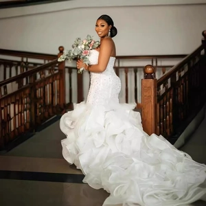 Elegant white mermaid wedding dress with lace embroidery and ruffled organza tail