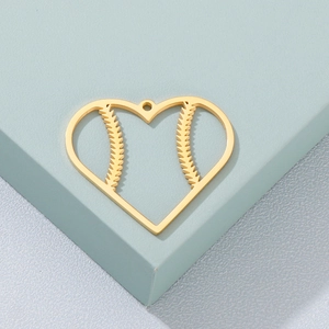Detailed macro shot of golden hollow heart charm with baseball stitch texture for DIY jewelry