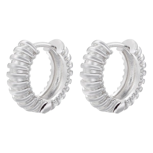 Macro detail of textured silver hoop earrings with spiral ribs and beaded edge accents