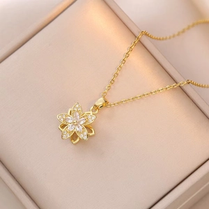 Detailed macro view of the golden rotating flower pendant with sparkling zircons