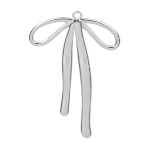 Macro detail of a silver bow-shaped stainless steel pendant with a polished metallic finish