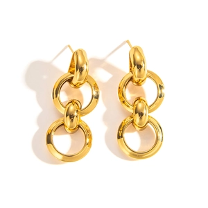 Macro shot of polished gold-plated double nested geometric hoop earrings in a minimalist style