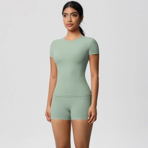 Detail of sage green yoga set showing high-waisted shorts and slim fit short sleeve t-shirt