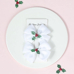 Christmas hair clips set with two white bows featuring holly leaf and berry decorations