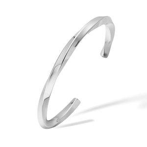Macro shot of silver twisted geometric open bangle with a polished reflective finish