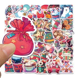 Detail showing various Christmas stickers including snowman and bear on a hand for scale