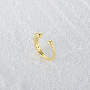Macro shot of S925 sterling silver ear cuff with gold plating and sparkling cubic zirconia
