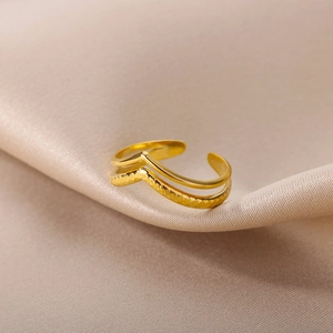 Macro detail of 18k gold plated double-layer open ring with geometric braided texture