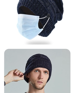Detail view of dark blue ribbed knit beanie with side buttons to hold face mask straps