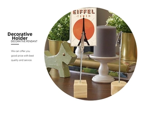 Detailed view of wooden photo holders with metal clips in a warm home office setting