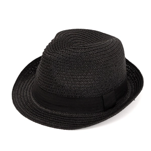 Detail of the woven texture and black ribbon bow on this stylish summer straw fedora hat