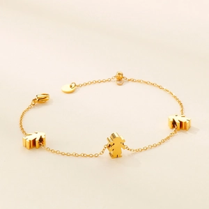 Elegant gold-plated stainless steel bracelet featuring three cartoon figure pendants