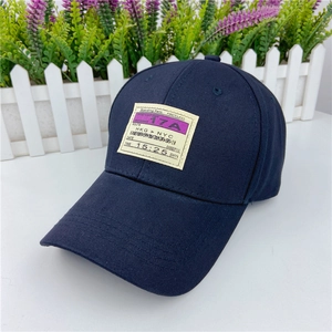 Detail of navy blue cotton baseball cap featuring a unique boarding pass fabric patch