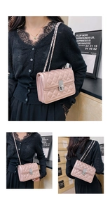 Detailed view of pink quilted leather crossbody bag with silver hardware and chain strap