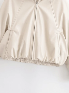 Detail of beige faux leather jacket featuring metal zipper and elastic ribbed hemline
