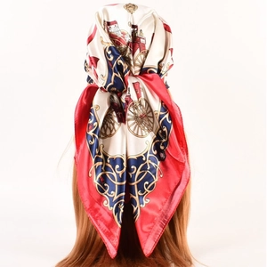 Detail of vintage horse carriage print silk scarf styled as a hair wrap for women