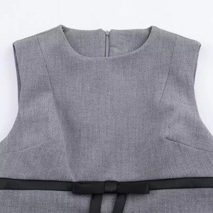 Grey mini dress with a round neck and black ribbon bow detail at the waist