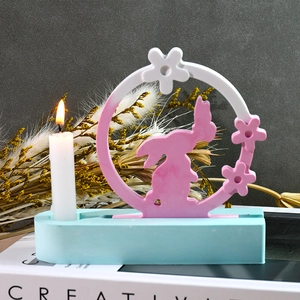 Detail of DIY silicone mold resin base featuring a pink rabbit silhouette and candle