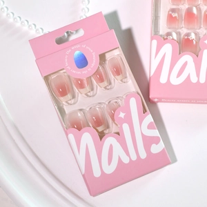 Pink gradient cat-eye press-on nails with glitter and pearl necklace on white background