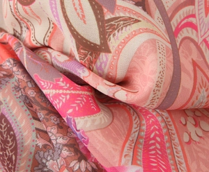 Close-up of lightweight paisley and floral printed fabric with pink and brown tones