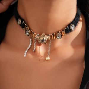 Detail of black velvet choker with gold star pendant and rhinestone fringe tassels