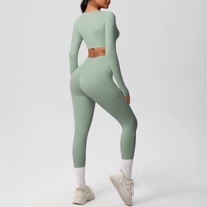 Detail of sage green yoga set featuring high waist leggings with side pockets and long sleeves