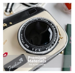 Detailed macro view of cream PU leather camera-shaped bag with gold hardware and stitching