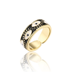 Macro detail of adjustable evil eye ring with black and white enamel in gold finish