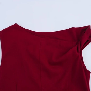 Detail of wine red linen midi dress featuring a pleated neckline and wide shoulder cutouts