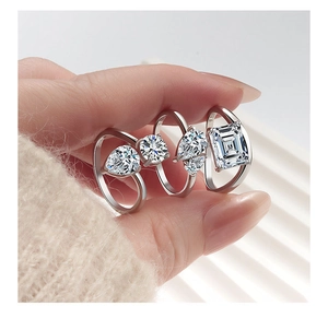 Detailed view of S925 sterling silver rings with various gemstone cuts on a hand