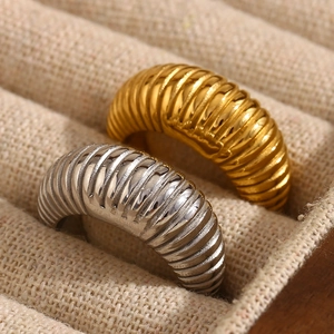 Minimalist wide ribbed croissant rings in 18K gold and silver finish on linen display