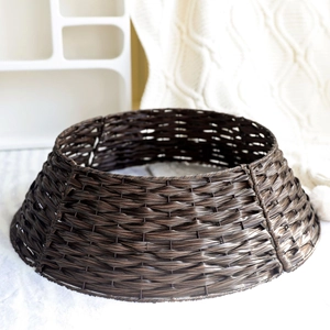 Dark brown woven Christmas tree collar for holiday base decoration in cozy indoor setting