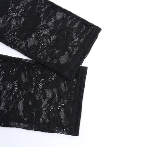 Close-up detail of the intricate floral lace patterns on the black sheer sleeve cuffs