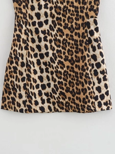 Close-up of the leopard print fabric texture and high-quality hem stitching on the dress