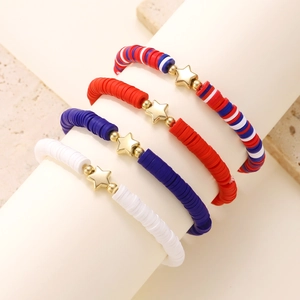 Close-up of four red white and blue Heishi bead bracelets with golden star charms
