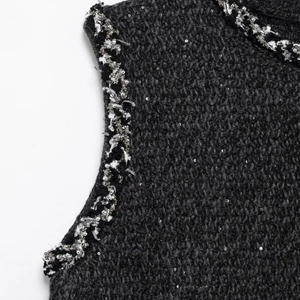Elegant black sleeveless sequin dress with woven trim detail and metallic highlights