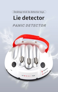 Detailed view of desktop lie detector with metallic sensor points and red hand strap