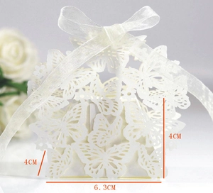 Detail view of white laser-cut butterfly candy box with ribbon and dimensions of 6.3cm x 4cm