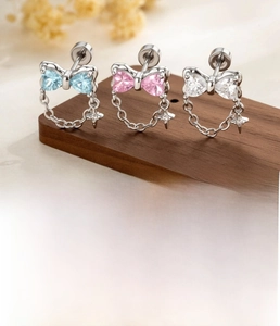 Bowtie stud earring detail in silver titanium steel with colorful zircon stone inlay