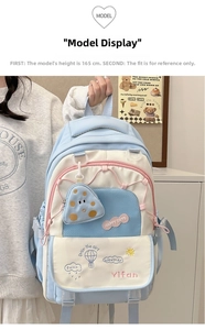 Detail of light blue school backpack with cute cloud embroidery and functional pockets