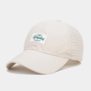 Detail of breathable mesh holes and Paradise woven label on quick-dry baseball cap