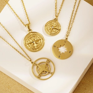 Vintage gold compass pendant necklaces for women featuring NSEW directional engravings