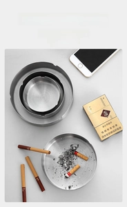 Three sizes of silver stainless steel ashtrays stacked to show durable metallic texture